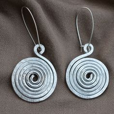 Aluminum earrings, Wire wrapped jewelry handmade, Spiral earrings, Long aluminum earrings. FREE SHIPPING WORLDWIDE. Aluminum ia a wonderful material for earrings because it is lightweight and won't tarnish like silver. And shiny. These spiral earrings were shaped with thick aluminum wire, hammered for strength and texture. Handmade Silver Swirl Earrings, Handmade Swirl Earrings As Gift, Handmade Swirl Earrings For Gifts, Spiral Silver-plated Wire Earrings, Unique Handmade Spiral Earrings, Handmade Spiral Metal Hoop Earrings, Spiral Silver Plated Wire Earrings For Gift, Spiral Silver Plated Wire Earrings As Gift, Handmade Spiral Wrap Earrings