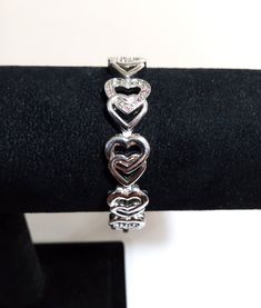 Silver Tone Heart Panel Link Cuff Bracelet; Silver Heart Link Bracelet; Link Bracelet; Heart Bracelet; Panel Bracelet; Silver Heart Bracelet This is a lovely silver tone heart panel link bracelet.  Features pink and clear tiny rhinestones toward the middle.  Measures 7.25" x 1/2".  Made of stainless steel I think.  Very strong and sturdy bracelet. Has a box clasp. Preowned gently worn with little to no wear.  See pics for details. ** I offer combined shipping 4.00 first item and .50 each additio Adjustable Metal Heart Bracelet For Valentine's Day, Adjustable Heart-shaped Metal Bracelets, Heart-shaped Metal Bracelets For Wedding, Heart Shaped Metal Bracelets For Wedding, Silver Metal Heart Bracelet For Wedding, Adjustable Double Heart Metal Bracelet, Adjustable Double Heart Bracelet, Anniversary Double Heart Bead Bracelets, Anniversary Bracelets With Heart Beads