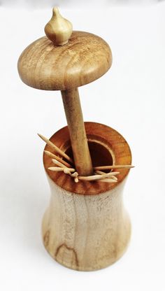 a small wooden object with some sticks sticking out of it