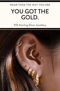 a woman wearing ear piercings with the words, you got the gold