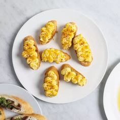 there are several different types of food on the plates next to each other, including bread