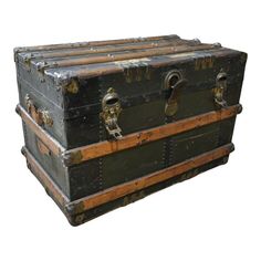 two trunks stacked on top of each other in front of a white background and one is empty