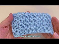 someone is holding up a blue crochet dishcloth