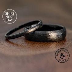 two wedding rings sitting on top of a wooden table