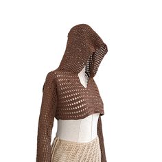 a mannequin wearing a brown knitted sweater and skirt with an open hood