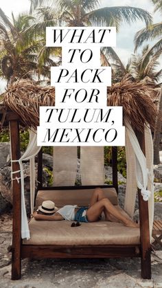 a woman laying on top of a bed under a canopy next to palm trees and the words what to pack for tulum mexico