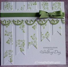 a close up of a greeting card with a green bow on it's side