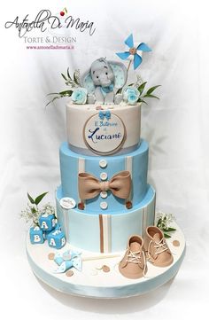 a three tiered cake decorated with baby items