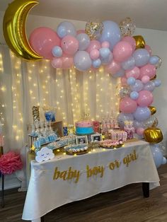 a baby boy or girl birthday party with balloons and cake