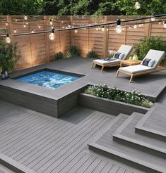 an outdoor hot tub in the middle of a deck with lounge chairs and string lights