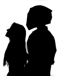 two people standing next to each other in silhouette