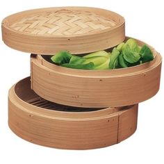 three bamboo steamers filled with green vegetables