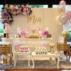 the dessert table is decorated with pink, white and gold decorations for a baby shower