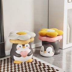 two little penguins with donuts on their heads are sitting in front of a mirror