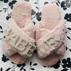 a pair of pink slippers with the word daddy written on them and sequins