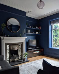 a living room with blue walls and a fireplace