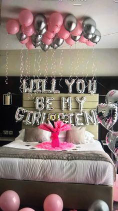 a bedroom decorated with balloons and streamers for someone's 30th birthday party in pink, silver and black