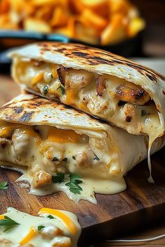 two quesadillas are sitting on a cutting board