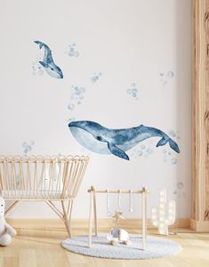 two dolphins are swimming in the ocean with bubbles on the water wall decals and a baby's crib