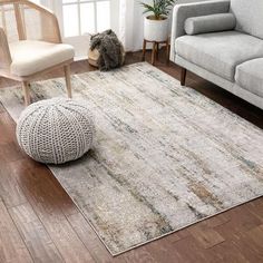 a living room with two couches, a chair and a rug on the floor