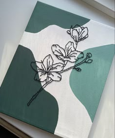 a white and green painting with flowers on it