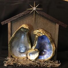 a nativity scene made out of wood with two pieces of glass in the manger