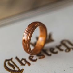 two wedding rings sitting on top of a piece of paper