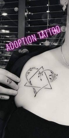 a woman with a tattoo on her chest and the caption above it says, adoption tattoo