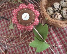 a basket filled with eggs sitting next to a bird's nest on top of a table