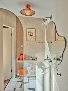 a bathroom with a sink, mirror and tiled floor