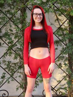 "This long sleeve black and red crop top fits soft and smooth against your body.  It is made from the popular and sporty raglan cut, and has a black body with red sleeves and collar. Worn With: Red Not So Short Mid Thigh Low Rise Shorts. The model is 5'5\" and wearing a size small. The fabric is stretchy and adjusts to the shape of your body. Although we make every effort to portray the accurate colors, colors and fit may vary slightly from the picture due to lighting and body type, as with all apparel. Size Chart (inches):                              S            M           L Bust                      27-30 31-34    34-37 Natural Waist        26            28    30 Length                        12.5             13     15  Materials:  95% rayon, 5% spandex. Custom print on this crop top: Red Fitted Crew Neck Crop Top, Red Long Sleeve Trendy Crop Top, Trendy Red Long Sleeve Crop Top, Red Fitted Sporty Crop Top, Sporty Fitted Red Crop Top, Sporty Red Crop Top With Crew Neck, Sporty Red Fitted Crop Top, Red Stretch Long Sleeve Crop Top, Red Long Sleeve Stretch Crop Top