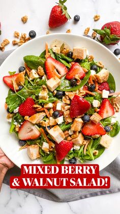 mixed berry and walnut salad on a white plate