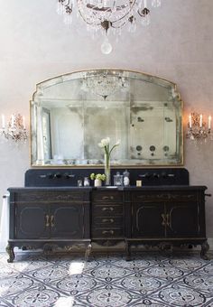 a large mirror sitting above a wooden dresser