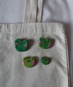 three green buttons sitting on top of a white bag