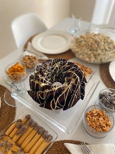 a table topped with lots of food and desserts