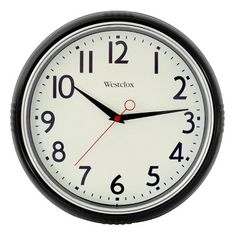 a black and white wall clock with the word westclox on it's face