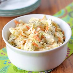 a white bowl filled with coleslaw and carrots