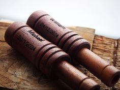 three wooden wine corks sitting on top of a piece of wood