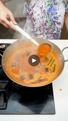 a woman cooking food on top of a stove with a spatula in her hand