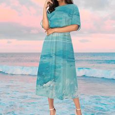 The skirt features a beautiful waves design inspired by the ocean, creating a unique and eye-catching look. The flowing lines and curves mimic the movement of the water, adding a sense of fluidity and grace to the garment. The combination of different shades of blue and white adds depth and dimension to the pattern, making it a versatile piece that can be paired with a variety of tops and accessories. Whether for a casual day out or a special occasion, this ocean waves pattern skirt is sure to m Flowy Blue Skirt For The Beach, Blue Beach Maxi Skirt, Blue Maxi Skirt For Beach, Beachy Blue Short Sleeve Dress, Blue Maxi Skirt For The Beach, Blue Mermaid Dress For The Beach, Blue Mermaid Dress For Beach, Green Mermaid Dress For Summer, Mermaidcore Fashion