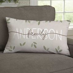 a couch with a pillow on it that says, anewronn and leaves