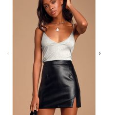 New With Tags Get Down With Your Bad Self In The Lulus Corte Black Vegan Leather Mini Skirt! Sleek, Vegan Leather Shapes This Always Trendy Mini Skirt Featuring A High Waist (With Tailored Pleats At Front And Back) That Carries Into A Fitted A-Line Silhouette And Flirty Mini Hem. A Chic Side Slit Adds A Sexy Touch! Hidden Back Zipper/Clasp. Unlined. 55% Polyurethane, 45% Cotton. Leather Mini Skirt Outfit, Rok Mini, Dressy Attire, Leather Skirt Outfit, Black Leather Mini Skirt, Black Leather Skirt, Vegan Leather Skirt, Chic Skirts, Miniskirt Outfits