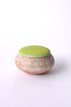 a white and green object sitting on top of a table