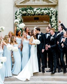 a group of people in formal wear standing on steps