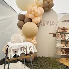 there are many balloons and teddy bears on display in this tented area for sale