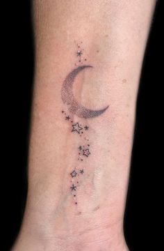 a foot with a small star and crescent tattoo on it