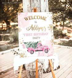 a pink truck birthday sign sitting on top of a wooden easel