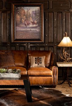 a living room filled with furniture and a painting on the wall