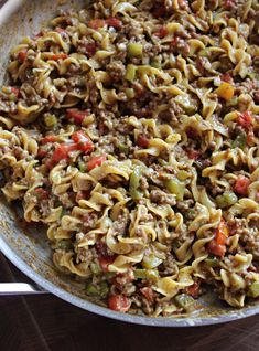 a skillet filled with pasta and vegetables