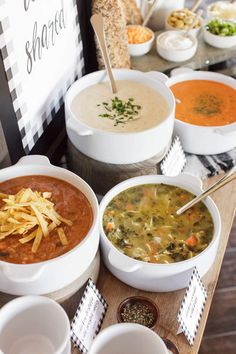 several bowls of soup are lined up on a table